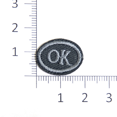 Термоаппликация «Ок» овал 1,5*2 см  т.-серый в интернет-магазине Швейпрофи.рф